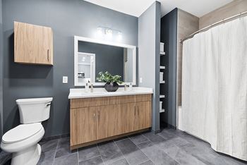Shaker vanities and tile flooring in bathrooms